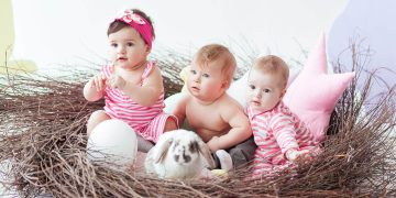 three-cute-little-babies-rabbit-with-easter-eggs-sitting-huge-nest-scaled